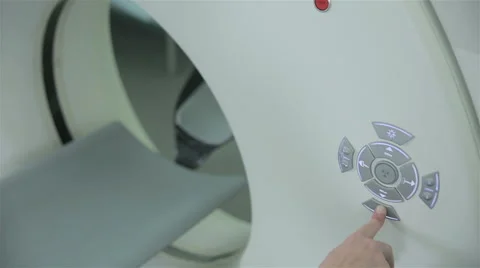 Unrecognizable doctor hands operates with Computerized Tomography CT MRI Scanner Video stock 67113703