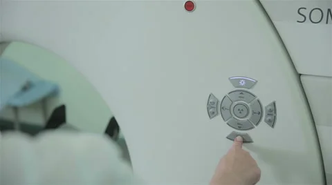 Unrecognizable doctor hands operates with Computerized Tomography CT MRI Scanner Video stock 67114080