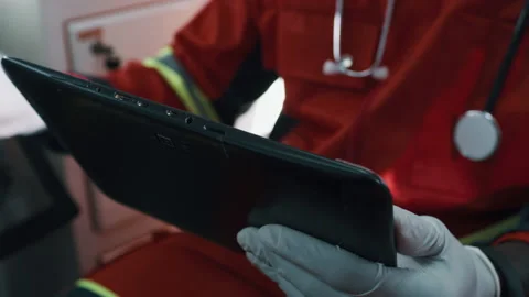 Unrecognizable doctor using tablet in ambulance Stock Footage 167965059