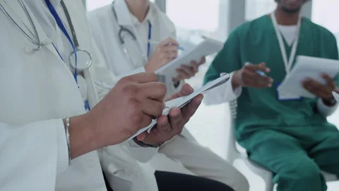 Unrecognizable Doctors Making Notes while Meeting at Clinic Stock Footage 287328495