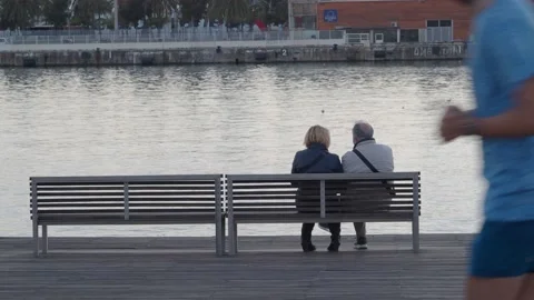 Unrecognizable elderly couple sitting on a bench Video stock 142971698