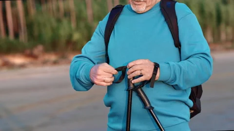 Unrecognizable elderly sport man taking Scandinavian walking stick cardio Stock Footage 252312696