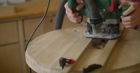 An unrecognizable face, a man working with a manual electronic milling cutter Stock Footage 251731560