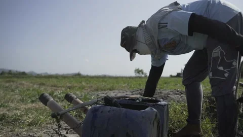 Unrecognizable farmer watering the fields in Laguna, Philippines Stock Footage 229718883