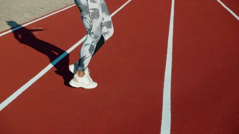 Unrecognizable female jumping rope in the rays of the sun. Woman legs jumping Stock Footage 161151160