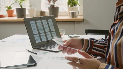Unrecognizable Female UI Engineer Examining New Wireframe Prototypes Stock Footage 327903354
