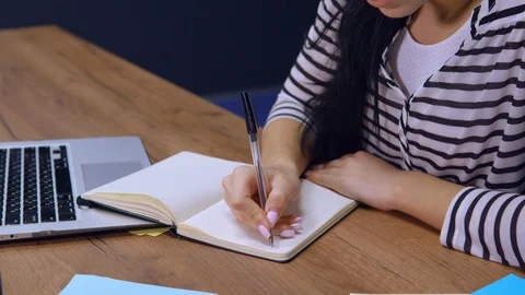 Unrecognizable female writes to do list at work Stock Footage 113452019