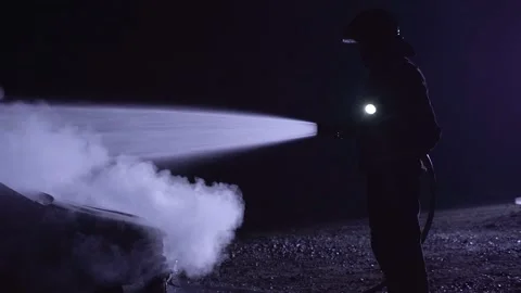 Unrecognizable fireman combating a fire with water hose. Stock-Footage 255132609