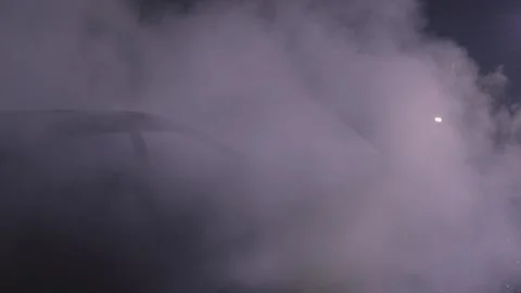 Unrecognizable fireman combating flames from burning car Video stock 275518181