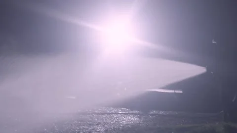 Unrecognizable fireman silhouette combating a fire of a burning car accident at Stock Footage 248905187