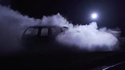 Unrecognizable fireman silhouette combating a fire of a burning car accident. Stock Footage 261977671