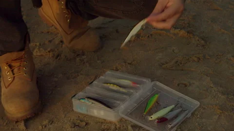 Unrecognizable fisherman selecting bait from box on coast Stock Footage 143912901