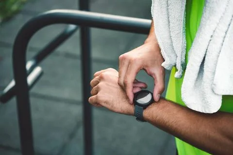 Unrecognizable fit man checking his smart watch after cardio Stock Photos