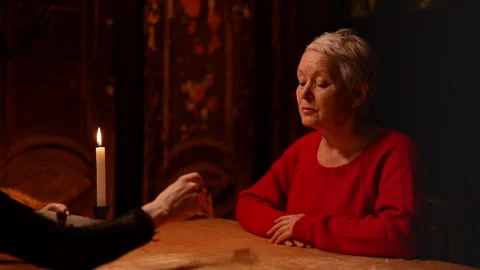 Unrecognizable fortune teller making tarot layout on table to mature adult Stock Footage 276333985