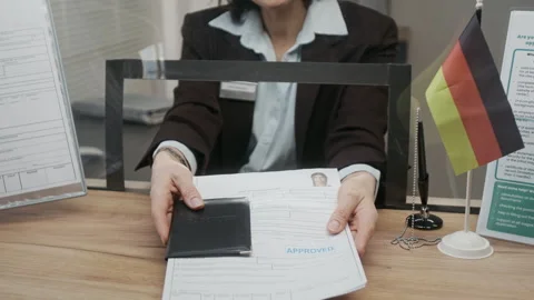 Unrecognizable German Consulate Agent Handing Back Approved Visa Documents Video stock 331509458