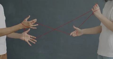 Unrecognizable girl and guy pulling strings wrapped around hands establishing Stock Footage 237319200