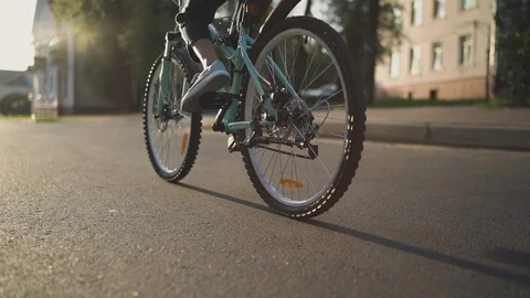 Unrecognizable girl child is starting movement on a bicycle Stock Footage 92334341