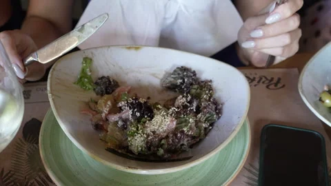Unrecognizable girl eats salad using cutlery. Stock Footage 248541571