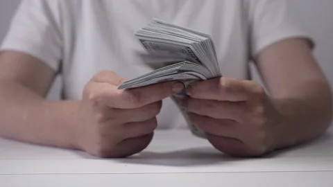 An unrecognizable girl leafs through banknotes. Stock Footage 275682148