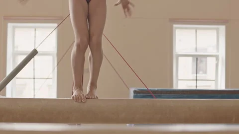 Unrecognizable Girl Showing Artistic Elements on Balance Beam Stock Footage 252265088