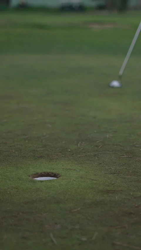 An unrecognizable golfer attempts a shot Stock Footage 272819174