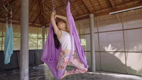 Unrecognizable group of people in corpse position during anti gravity yoga class Video stock 218354335
