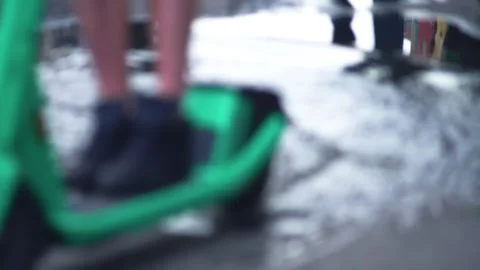 Unrecognizable guy on electric scooter driving through puddle, smearing mirror Video stock 254103540