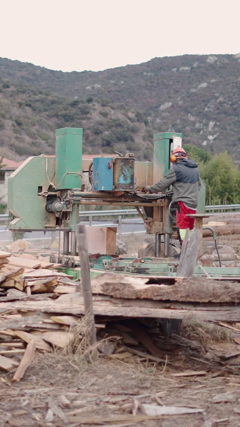 An unrecognizable guy operating a wood cutting machine Stock Footage 273178086