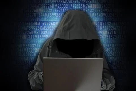 Unrecognizable hacker in front of computer – cybercrime concept Stock-Fotos