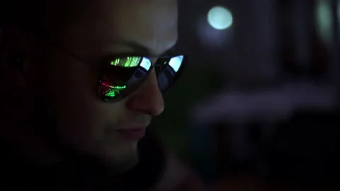 Unrecognizable hacker in glasses reflect the screen as in a matrix.. Male Stock Footage 237925714