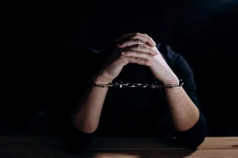 Unrecognizable hacker in handcuffs Stock Photos