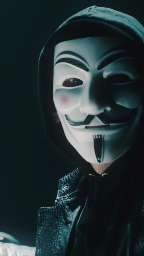 Unrecognizable hacker looking at camera Stock Footage 276572970