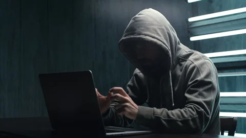 Unrecognizable hacker man stretching hands and starting to typing on laptop and Video stock 145121752