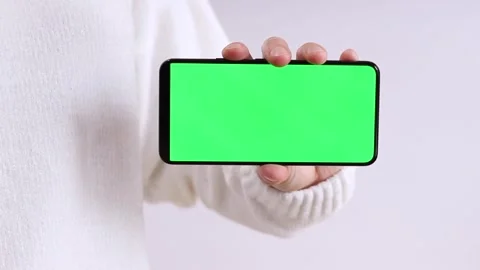 Unrecognizable hand holding chromakey mobile phone Stock Footage 295509688