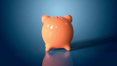 Unrecognizable hand is save money by throwing money into a piggy bank Banking Video stock 265936533