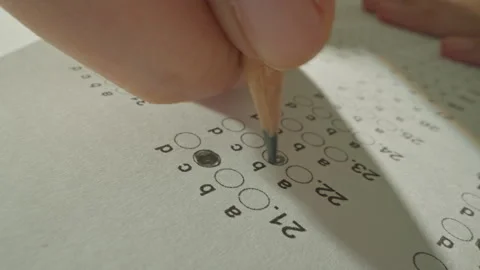 Unrecognizable hands filling up answer sheet with a pencil in exam room. Stock Footage 302517222