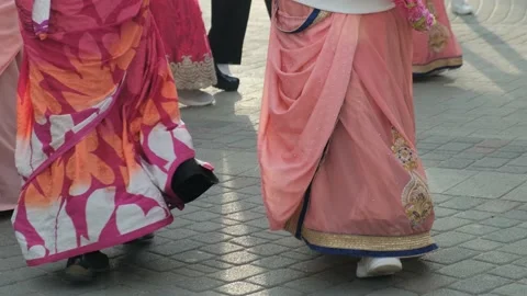 Unrecognizable Hare Krishna women dancing in traditional dresses on the street Stock Footage 235555710
