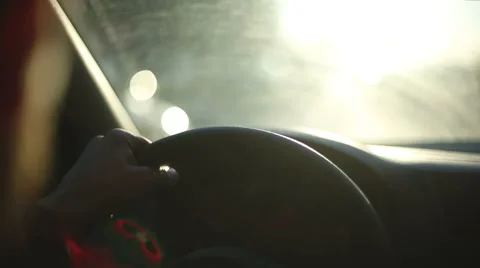 Unrecognizable human is driving car at sunset Stock Footage 48224496