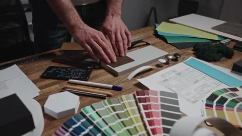 Unrecognizable interior designers select materials and color schemes for a Stock Footage 297050996