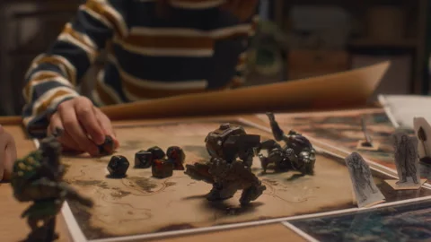 Unrecognizable Kid Looking at Polyhedral Dice and Board Game Elements Stock Footage 278006526