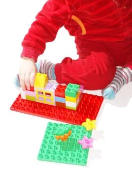 Unrecognizable kid in red, playing Stock Photos