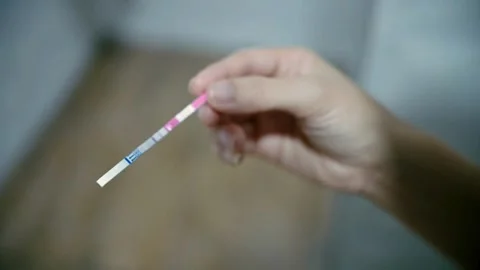 Unrecognizable lady looking negative one line result in bathroom Fertility an Stock Footage 265934428