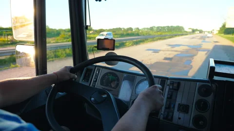 Unrecognizable lorry driver holding hands on steering wheel Stock Footage 125080081