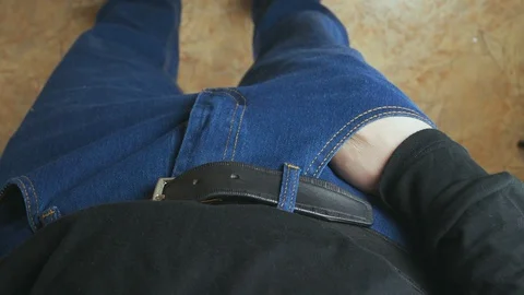 Unrecognizable male hand pulls out from his pocket a small bag of marijuana. Stock Footage 129695833