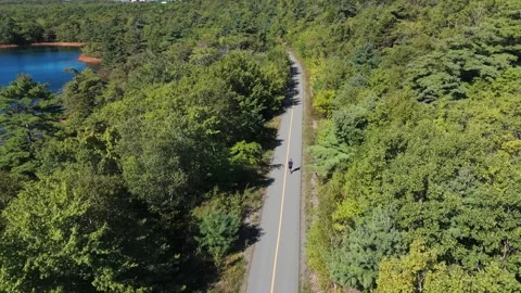 Unrecognizable Male Runner Jogging Through City Park Aerial Drone Footage Video stock 317901309
