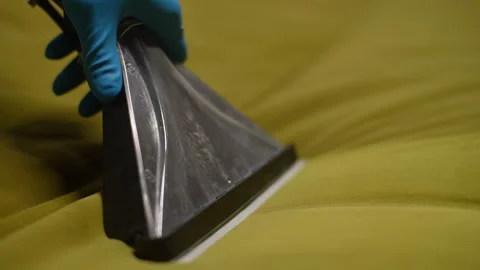 Unrecognizable male wearing gloves using wet vacuum cleaner to remove dirt and Stock Footage 297631459