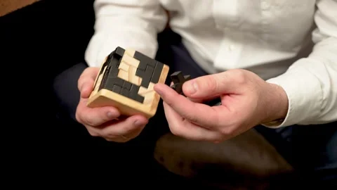Unrecognizable man assembling puzzle made of blocks to train intellectual Stock Footage 303151932