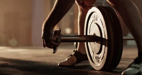 Unrecognizable man athlete adding weight plate on barbell Video stock 272371535