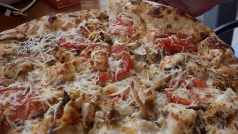 Unrecognizable man bites and eats a piece of pizza. Close-up view of pizza with Stock Footage 299699042