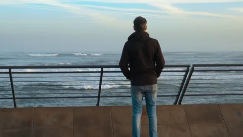 Unrecognizable man with black jacket looking to the Ocean  - Casablanca, Morocco Stock Footage 126012308